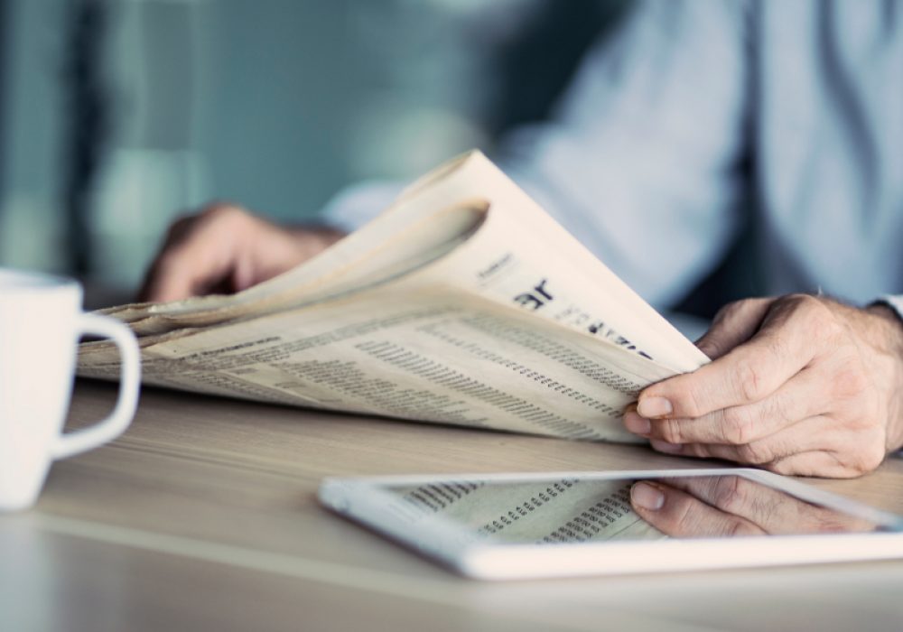 Businessman,Reading,The,Newspaper,On,Table