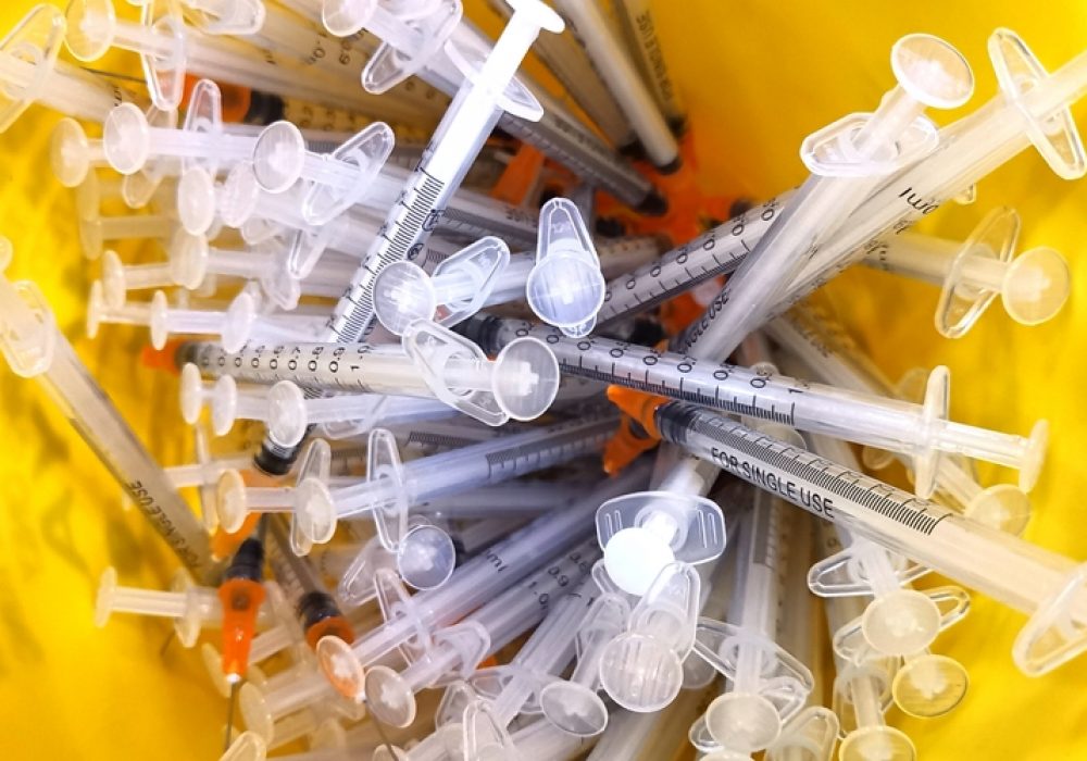 Close,Up,Of,The,Used,Vaccine,Needles,In,The,Sharp