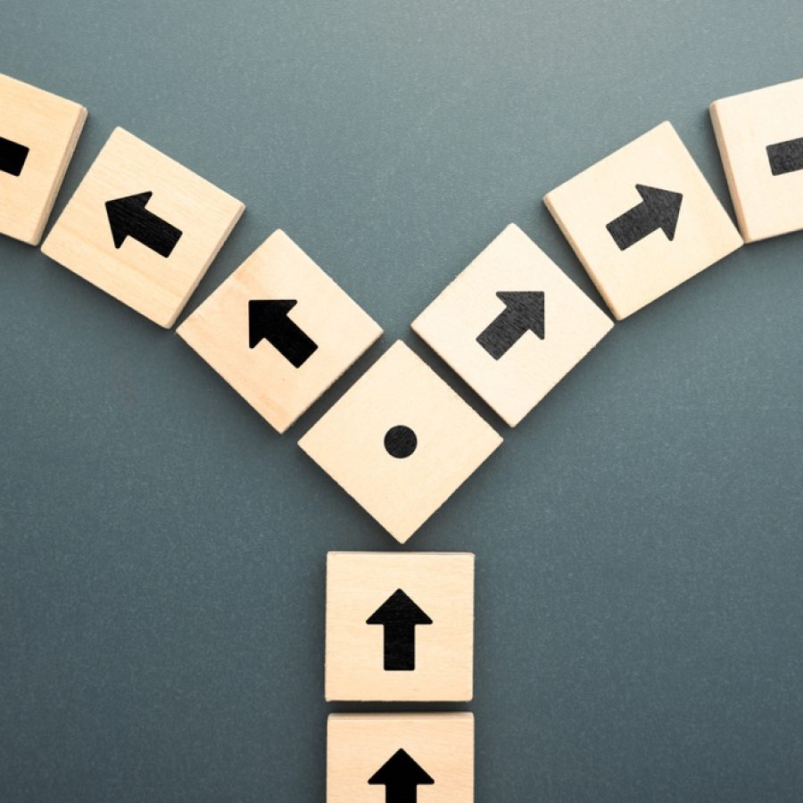 Wooden,Blocks,With,Arrows,Pointing,In,Opposite,Directions,Symbolize,Conflict