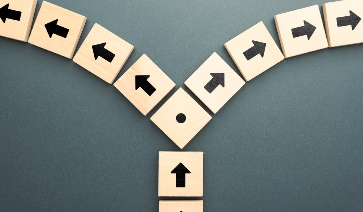 Wooden,Blocks,With,Arrows,Pointing,In,Opposite,Directions,Symbolize,Conflict