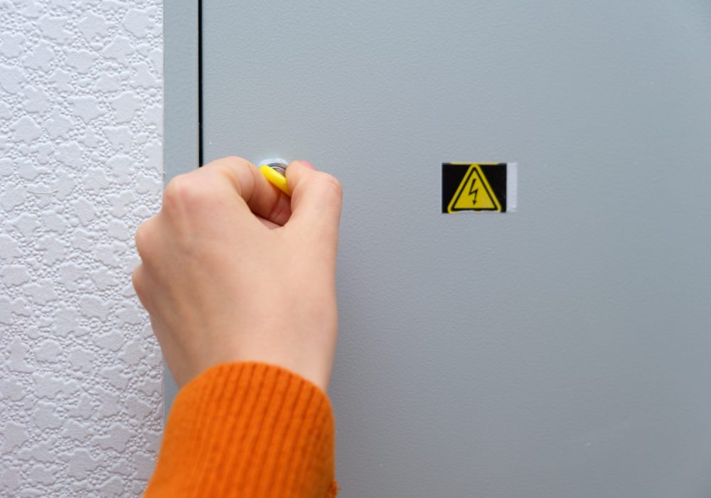 A,Woman's,Hand,Using,A,Yellow,Key,To,Open,An