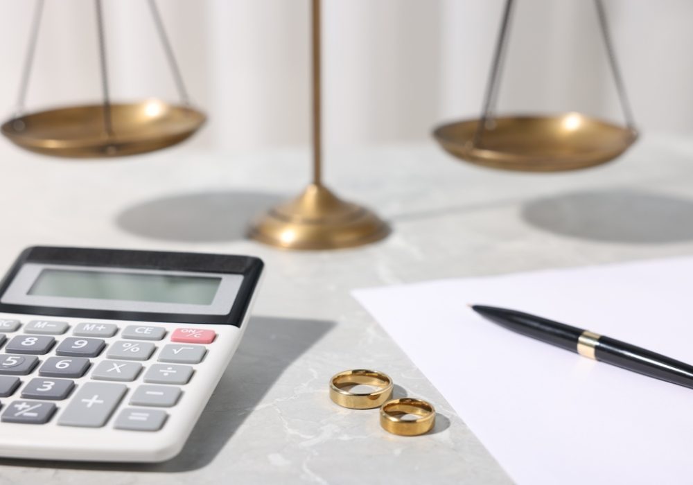 Alimony.,Wedding,Rings,,Calculator,,Document,,Pen,And,Scales,On,Grey