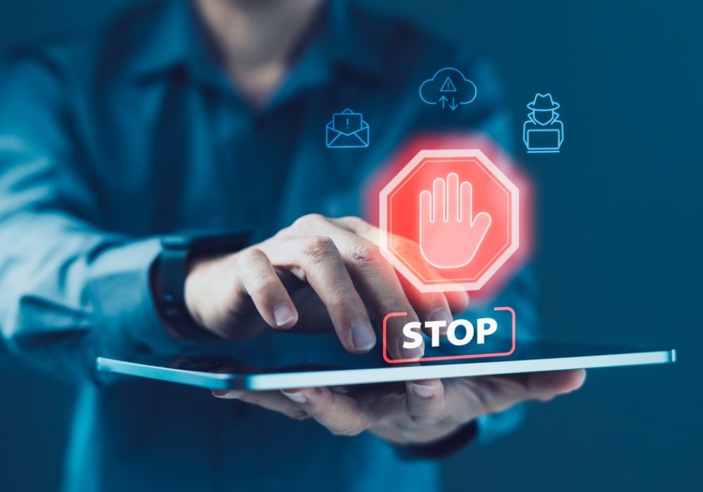 Business,User,Interacting,With,Tablet,Displaying,Stop,Warning,Icon,With