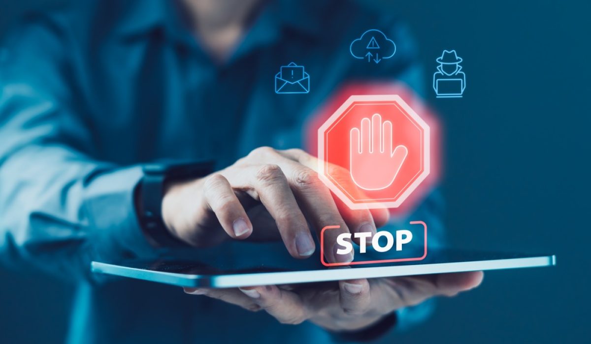 Business,User,Interacting,With,Tablet,Displaying,Stop,Warning,Icon,With