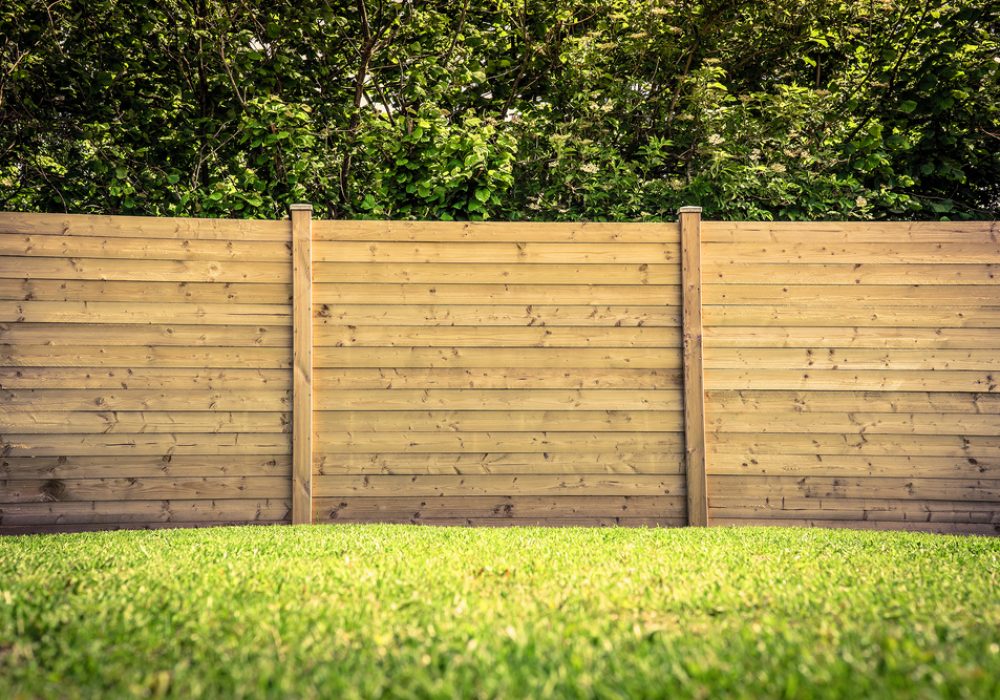 Wooden,Fence,On,A,Green,Lawn