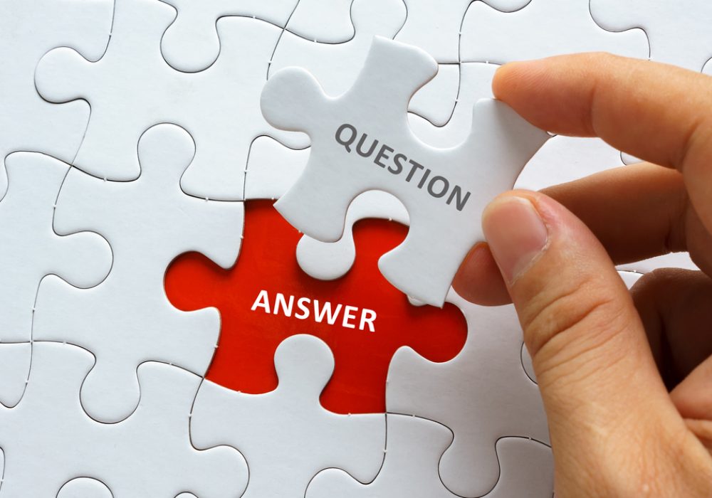 Hand,Holding,Piece,Of,Jigsaw,Puzzle,With,Word,Question,Answer.
