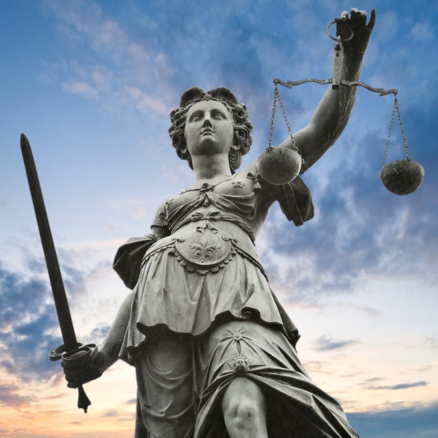 Justice,Statue,With,Sword,And,Scale.,Cloudy,Sky,In,The