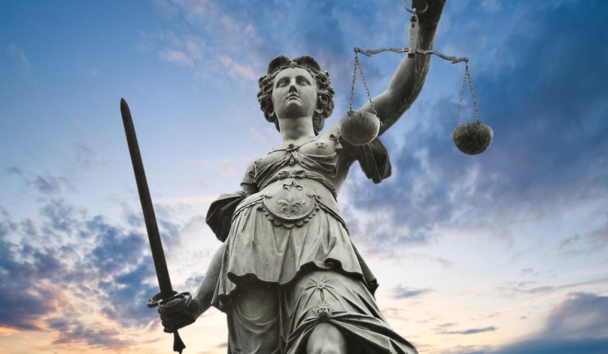 Justice,Statue,With,Sword,And,Scale.,Cloudy,Sky,In,The