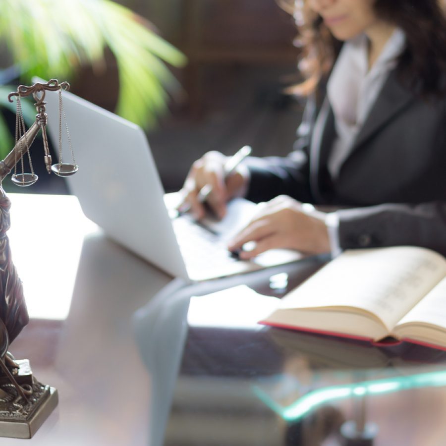 Lawyer,Office.,Statue,Of,Justice,With,Scales,And,Lawyer,Working