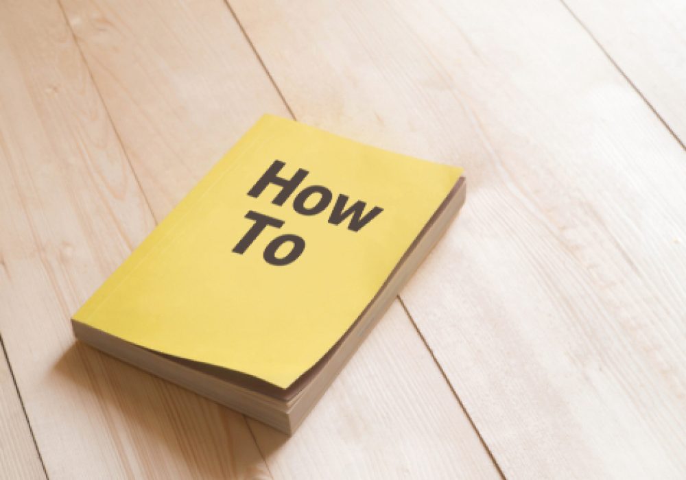 How,To,Book,Or,Guidebook,On,Wooden,Table